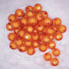 top view of a pile of 20mm Orange Translucent Faceted Bead in a bead Bubblegum Bead