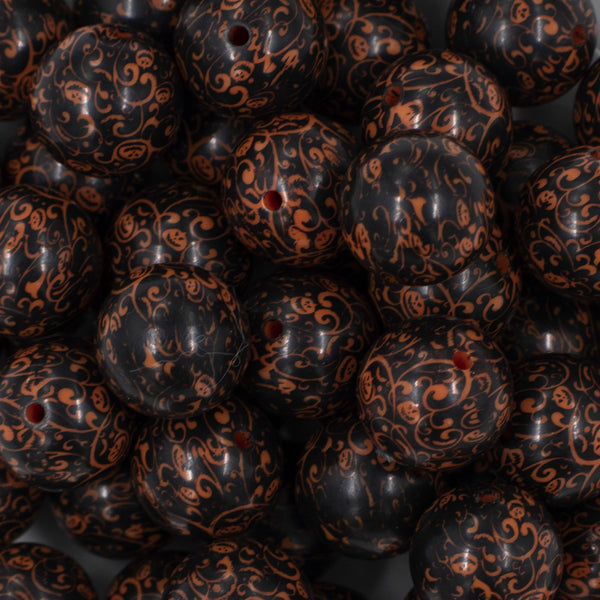 Close up view of a pile of 20mm Orange & Black Pumpkin Swirl Print chunky acrylic Bubblegum Beads