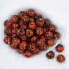Top view of a pile of 20mm Orange with Black Splatter Chunky Acrylic Bubblegum Beads