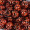 Close up view of a pile of 20mm Orange with Black Splatter Chunky Acrylic Bubblegum Beads