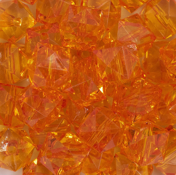 Close up view of a pile of 20mm Orange Transparent Cube Faceted Pearl Bubblegum Beads