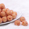 Front view of a pile of 20mm Orange Flower Rhinestone Bubblegum Beads