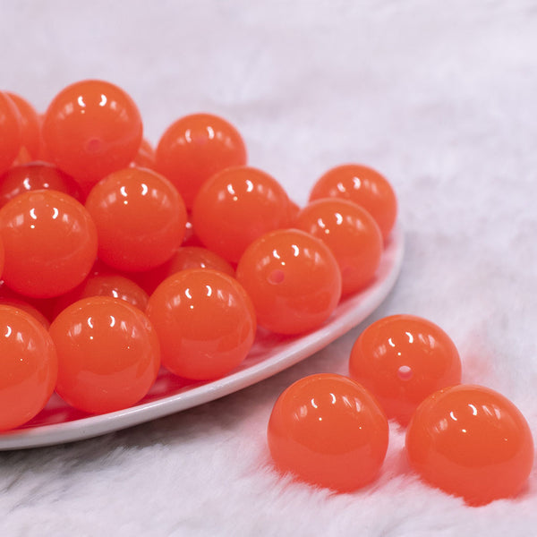 Front view of a pile of 20mm Orange Glow in the Dark Bubblegum Beads