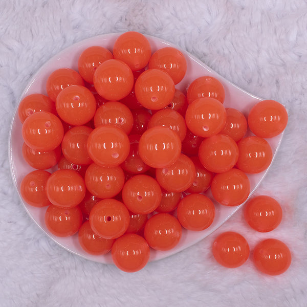 Top view of a pile of 20mm Orange Glow in the Dark Bubblegum Beads