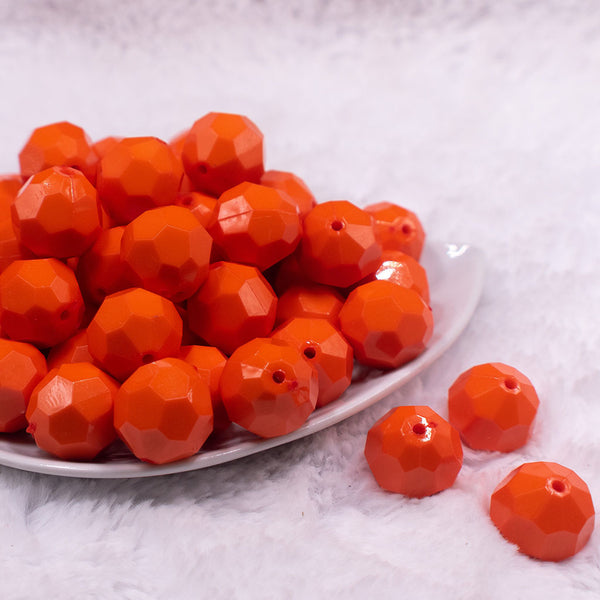 Front view of a pile of 20mm Orange Faceted Opaque Bubblegum Beads