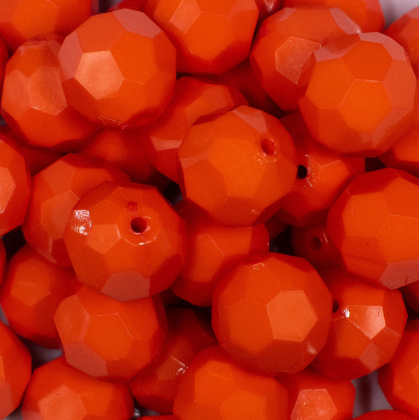 Close up view of a pile of 20mm Orange Faceted Opaque Bubblegum Beads