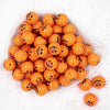 Top view of a pile of 20MM Jack O Lantern Pumpkin Face Halloween print Chunky Bubblegum Beads