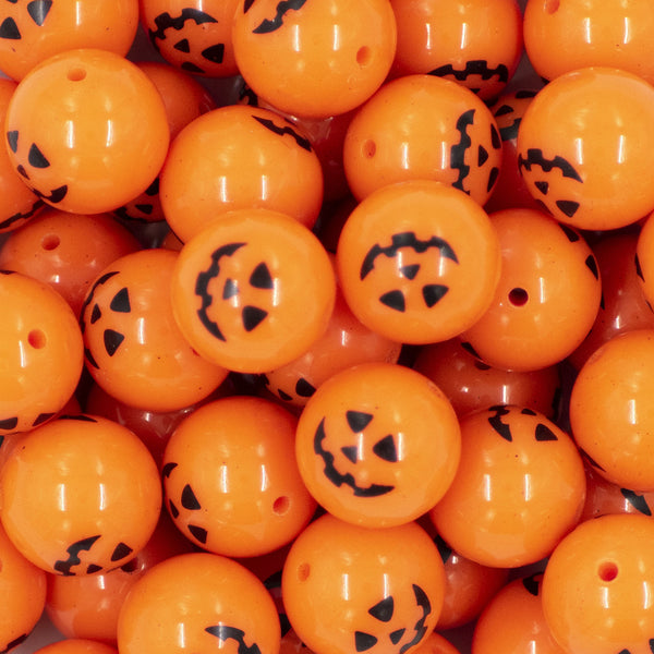 Close up view of a pile of 20MM Jack O Lantern Pumpkin Face Halloween print Chunky Bubblegum Beads