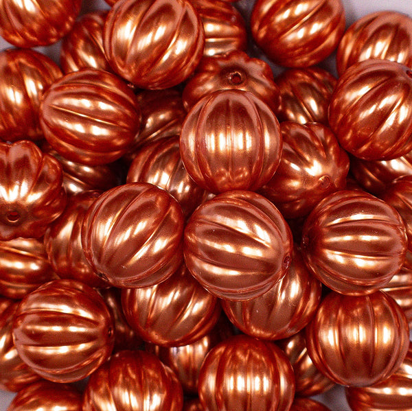 Close up view of a pile of 20mm Orange Pearl Pumpkin Shaped Bubblegum Bead