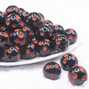 front view of a pile of 20mm Orange Polka Dots on Black Bubblegum Beads