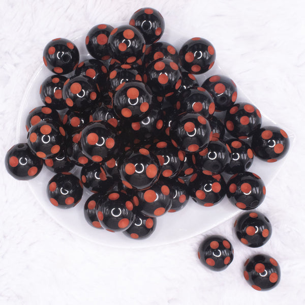 top view of a pile of 20mm Orange Polka Dots on Black Bubblegum Beads