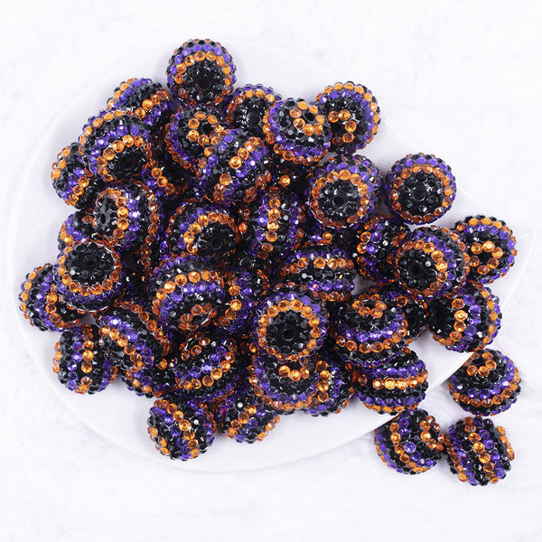 top view of a pile of 20mm Orange, Purple and Black Striped Rhinestone AB Bubblegum Beads