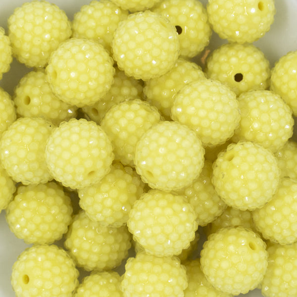 Close up view of a pile of 20mm Pastel Yellow Rhinestone Bubblegum Beads
