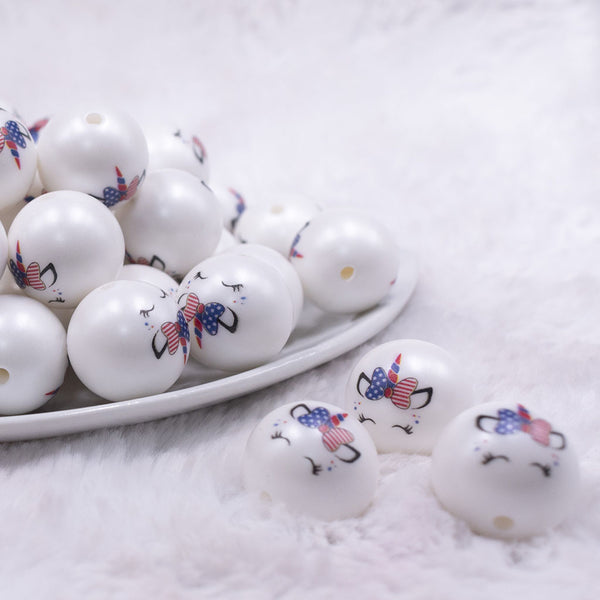 Front view of a pile of 20mm Patriotic Sleeping Unicorn Print on Matte White Acrylic Bubblegum Beads