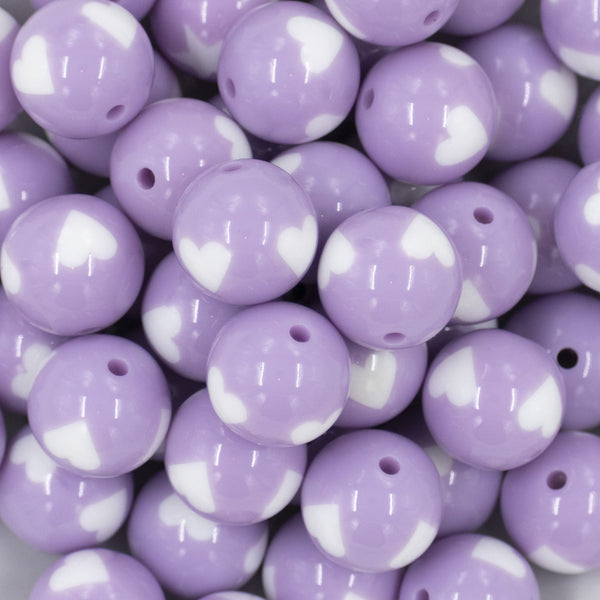 Close up view of a pile of 20mm Periwinkle Purple with White Hearts Bubblegum Beads