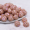 front view of a pile of 20mm Pink and Gold Striped Rhinestone AB Bubblegum Beads