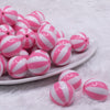 front view of a pile of 20mm Pink with White Stripe Beach Ball Acrylic Bubblegum Beads