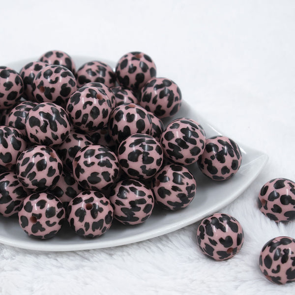 Front view of a pile of 20mm Pink & Black Cow Animal Print Acrylic Bubblegum Beads