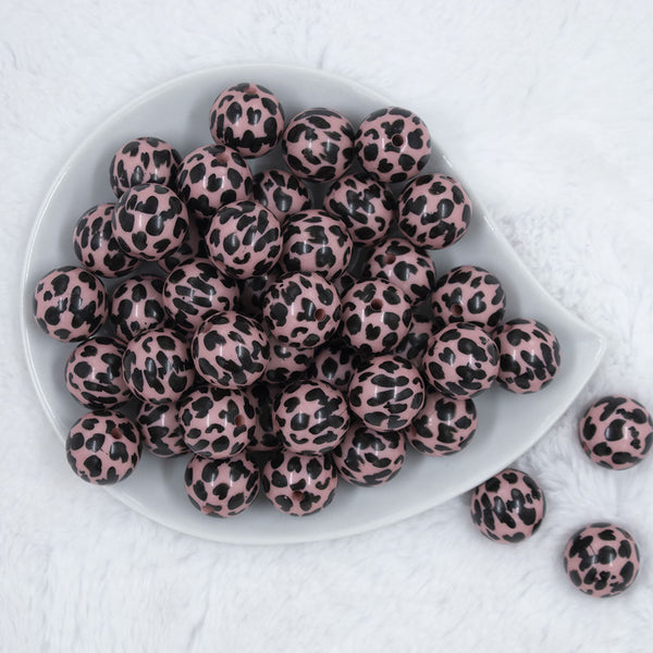 Top view of a pile of 20mm Pink & Black Cow Animal Print Acrylic Bubblegum Beads
