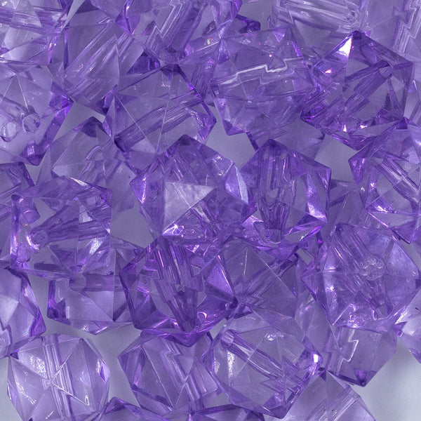Close up view of a pile of 20mm Purple Transparent Cube Faceted Pearl Bubblegum Beads