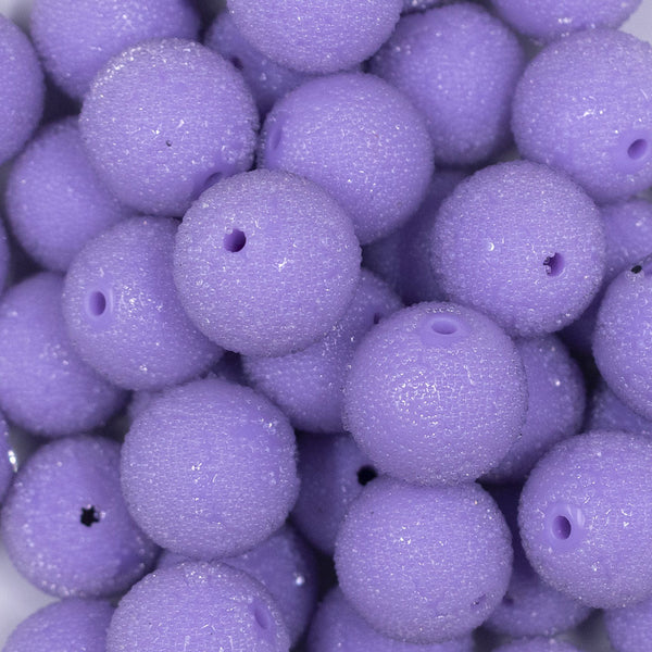 Close up view of a pile of 20mm Purple Sugar Glass Bubblegum Beads