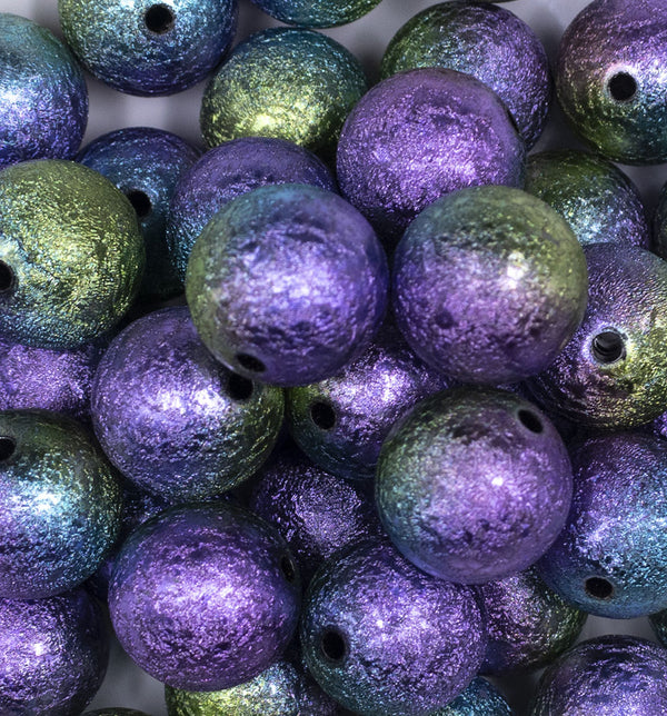 Close up view of a pile of 20mm Purple, Blue, & Green Stardust Ombre Shimmer Bubblegum Beads