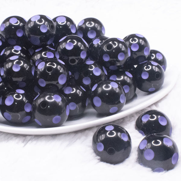front view of a pile of 20mm Purple Polka Dots on Black Bubblegum Beads