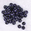 top view of a pile of 20mm Purple Polka Dots on Black Bubblegum Beads