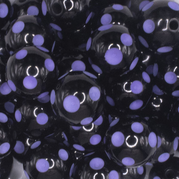 close up view of a pile of 20mm Purple Polka Dots on Black Bubblegum Beads