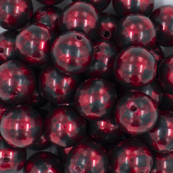 Close up view of a pile of 20mm Red & Black PEARL Plaid Print Acrylic Bubblegum Beads