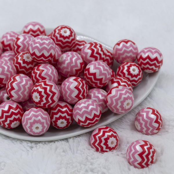 Front view of a pile of 20mm Red and Pink Chevron Bubblegum Beads