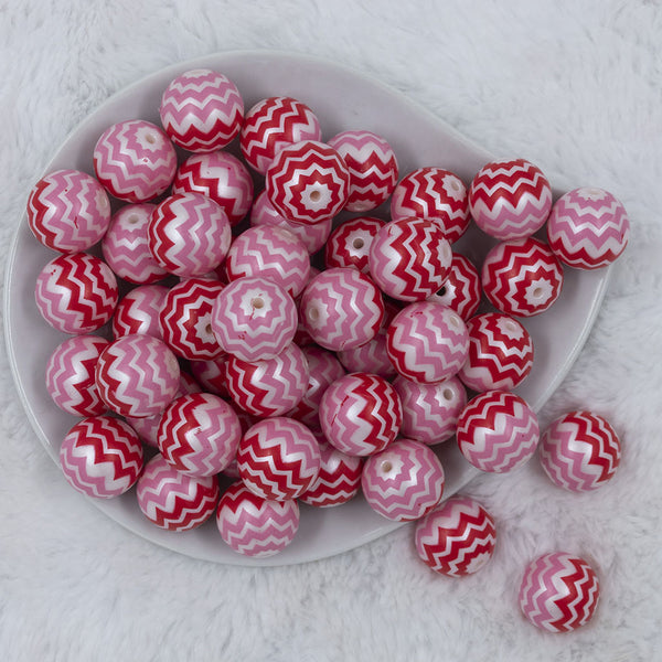 Top view of a pile of 20mm Red and Pink Chevron Bubblegum Beads