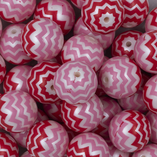 Close up view of a pile of 20mm Red and Pink Chevron Bubblegum Beads