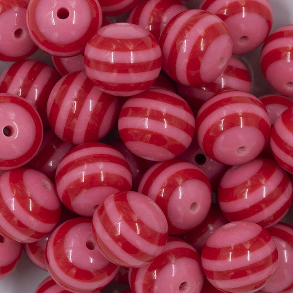Close up view of a pile of 20mm Multi Red & Pink Stripe Acrylic Chunky Bubblegum Beads