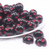 front view of a pile of 20mm Red Polka Dots on Black Bubblegum Beads