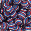 Close up view of a pile of 20mm Red, White & Blue Striped Rhinestone AB Bubblegum Beads