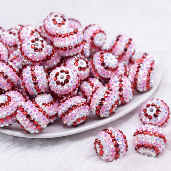 front view of a pile of 20mm Pink, Red and White Striped Rhinestone AB Bubblegum Beads