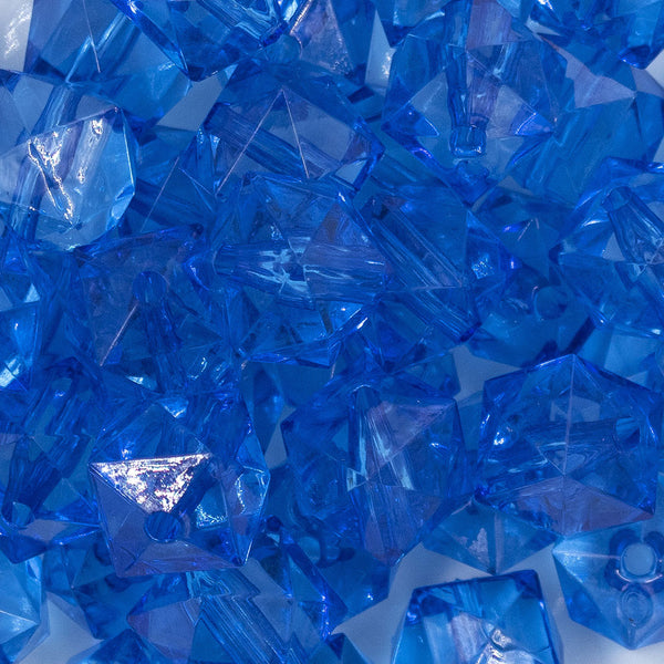 Close up view of a pile of 20mm Royal Blue Transparent Cube Faceted Pearl Bubblegum Beads
