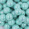 Close up view of a pile of 20MM Seafoam Green AB Solid Chunky Bubblegum Beads