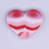 Macro view of a pile of 20mm Red & Pink heart shaped silicone bead