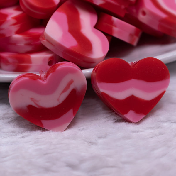 Macro view of a pile of 20mm Red and Pink heart shaped silicone bead