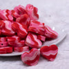 Front view of a pile of 20mm Red and Pink heart shaped silicone bead