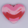 Close up view of a pile of 20mm Red and Pink heart shaped silicone bead