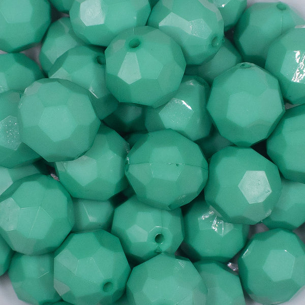 Close up view of a pile of 20mm Teal Faceted Opaque Bubblegum Beads