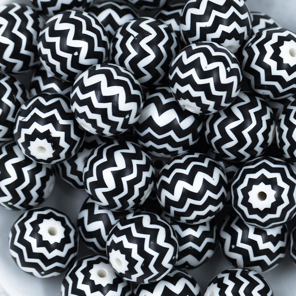 Close up view of a pile of 20mm Black with Silver Chevron Bubblegum Beads
