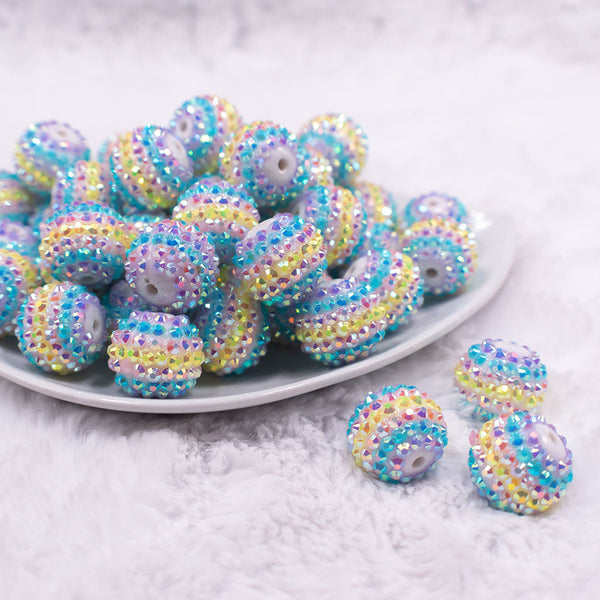 Front view of a pile of 20mm Pastel Striped Rhinestone AB Bubblegum Beads
