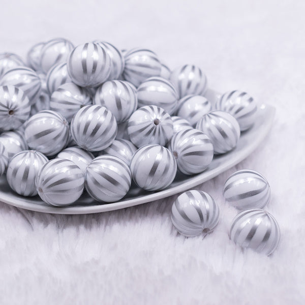 Front view of a pile of 20mm White with Silver Pin Stripes Acrylic Bubblegum Beads