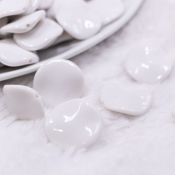 Macro  view of a pile of 20mm White Opaque Wavy Flat Shaped Jewelry Bead