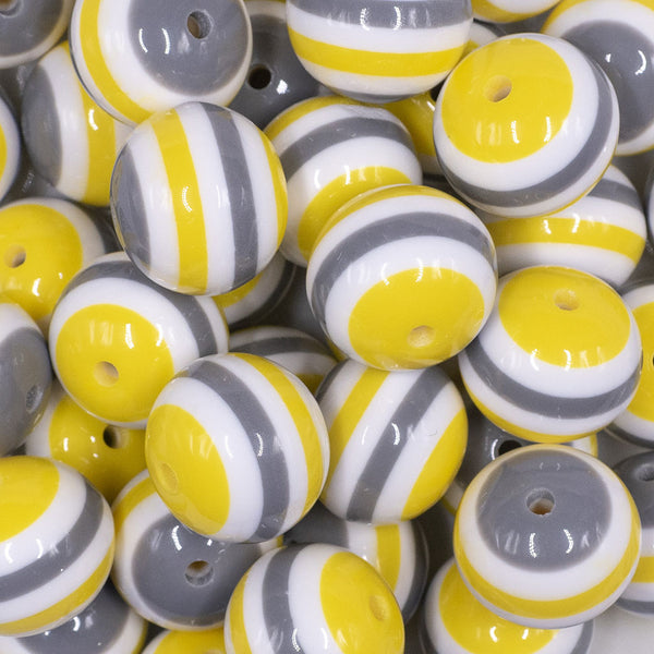 Close up view of a pile of 20mm Yellow, Gray & White Stripes Chunky Bubblegum Jewelry Beads