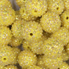 Close up view of a pile of 20mm Yellow Flower Rhinestone Bubblegum Beads